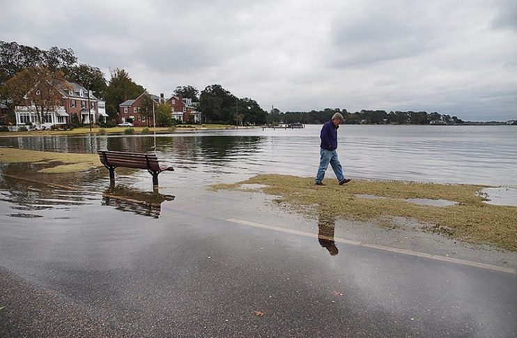 S. Stiles walking on flooded road
