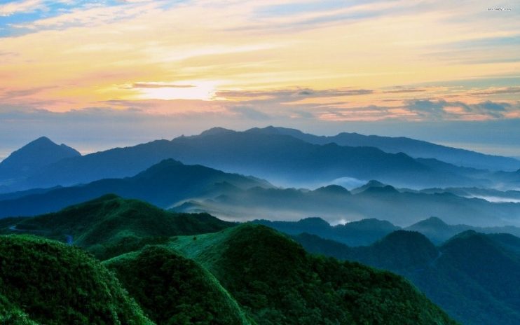 sun over the mountains and trees