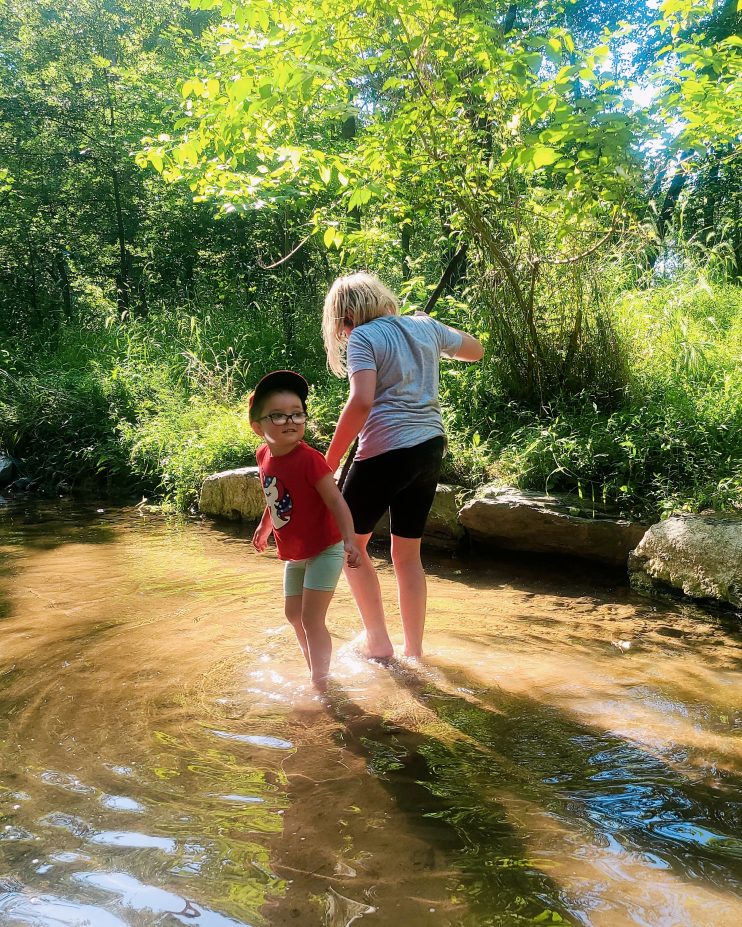 Two girls wading in the water