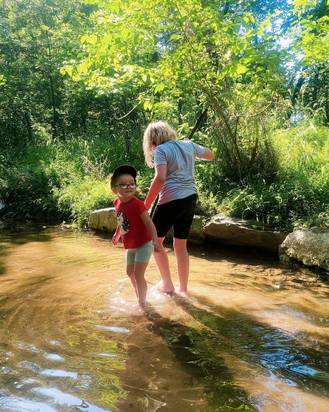 Two girls wading in the water