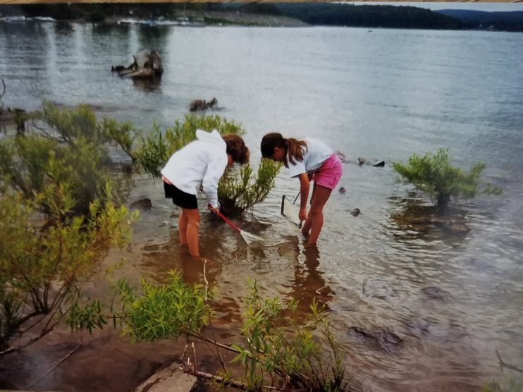 Photo of two people looking for crayfish