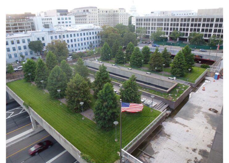 Photo of a green roof from above featuring trees and an american flag
